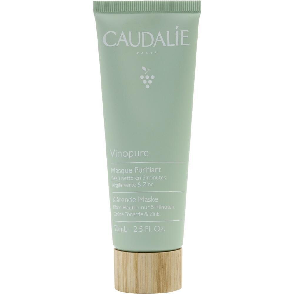 Eine gr&uuml;ne Tube Gesichtsmaske mit Holzdeckel und wei&szlig;er Aufschrift.