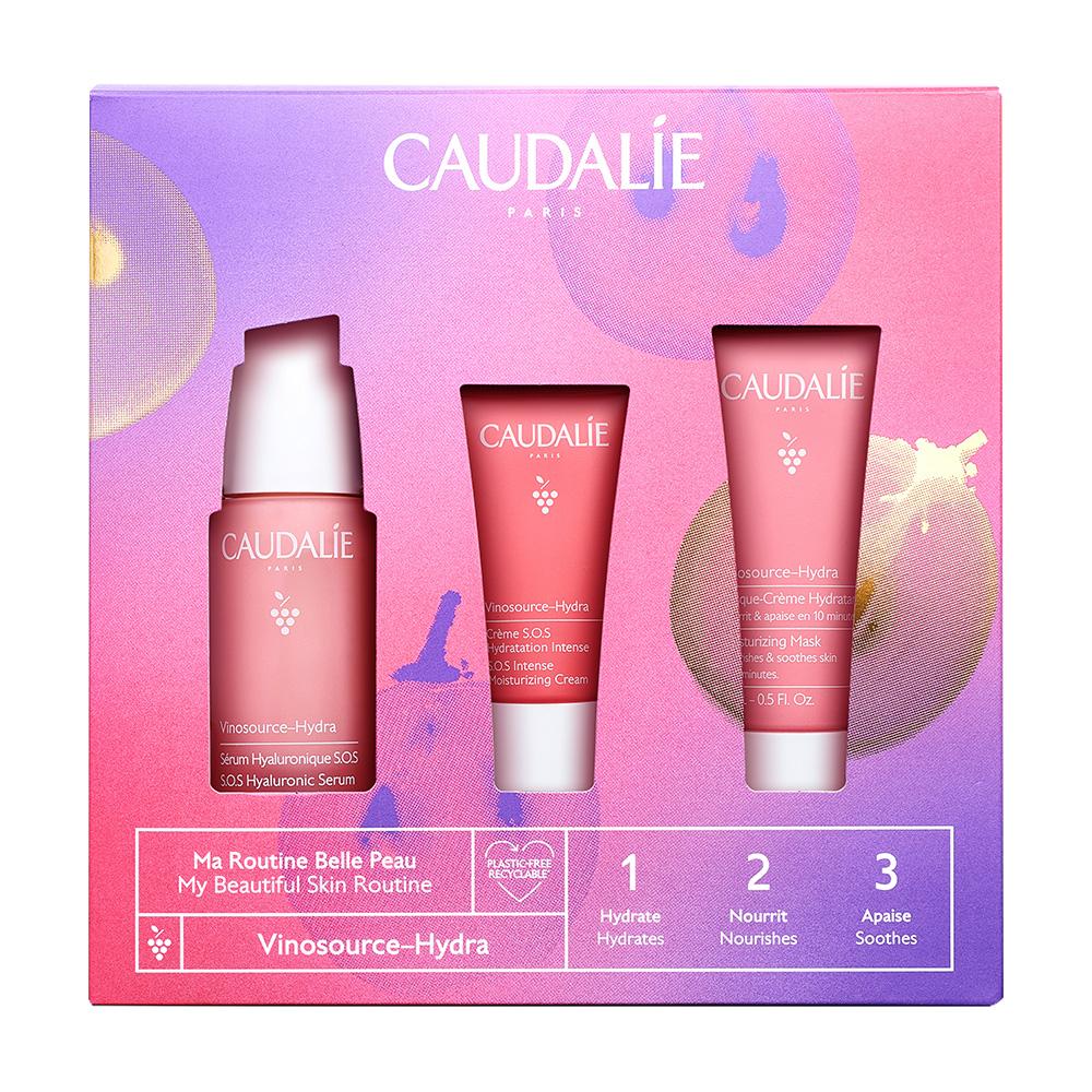 Drei pinke Hautpflegeprodukte in einer bunten Verpackung von Caudalie.